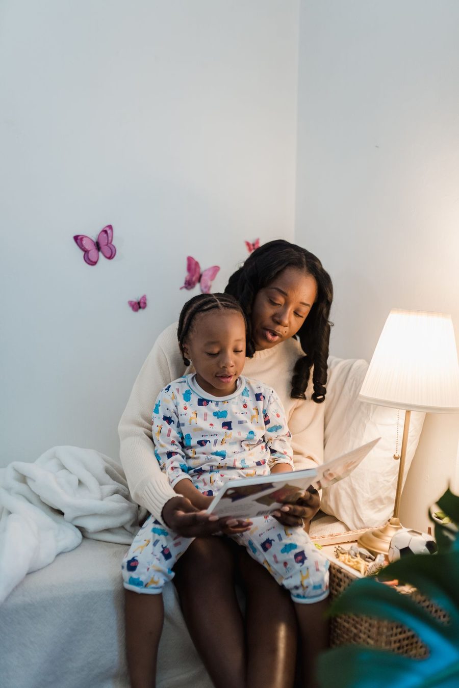 A mother and child reading together before bed.