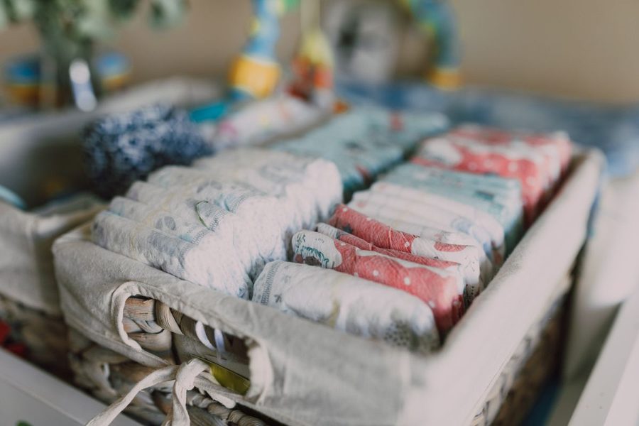A woven basket holding diapers and everyday baby essentials.
