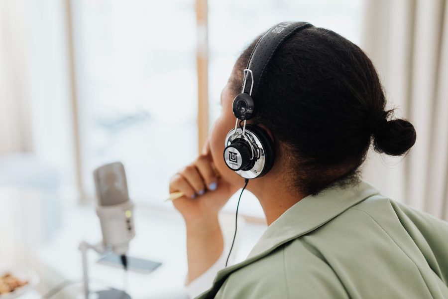 A woman listening to audio with headphones.