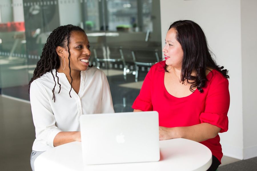 Two women sharing perspectives in a conversation.