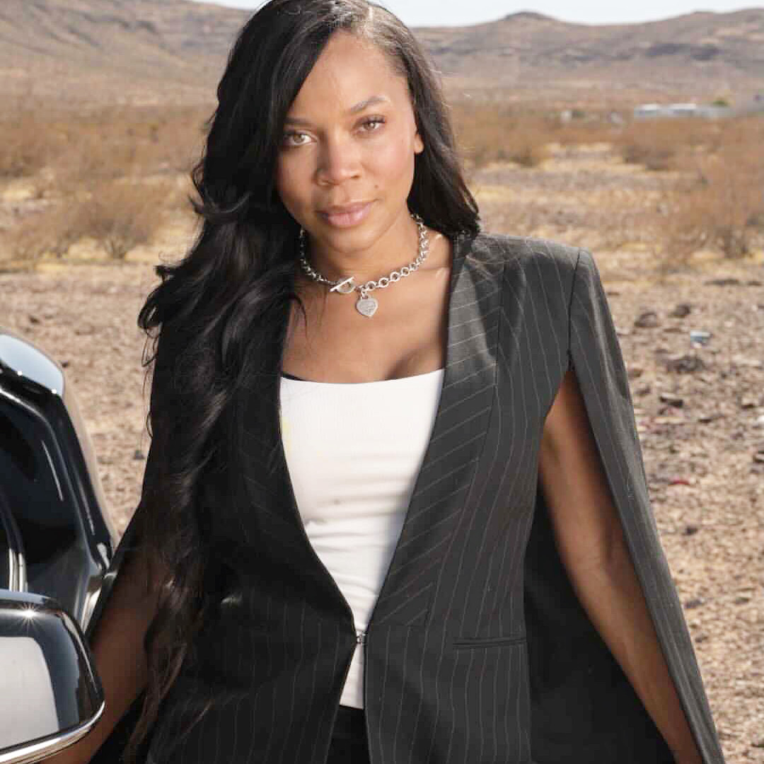 Nikki in a charcoal blazer outdoors