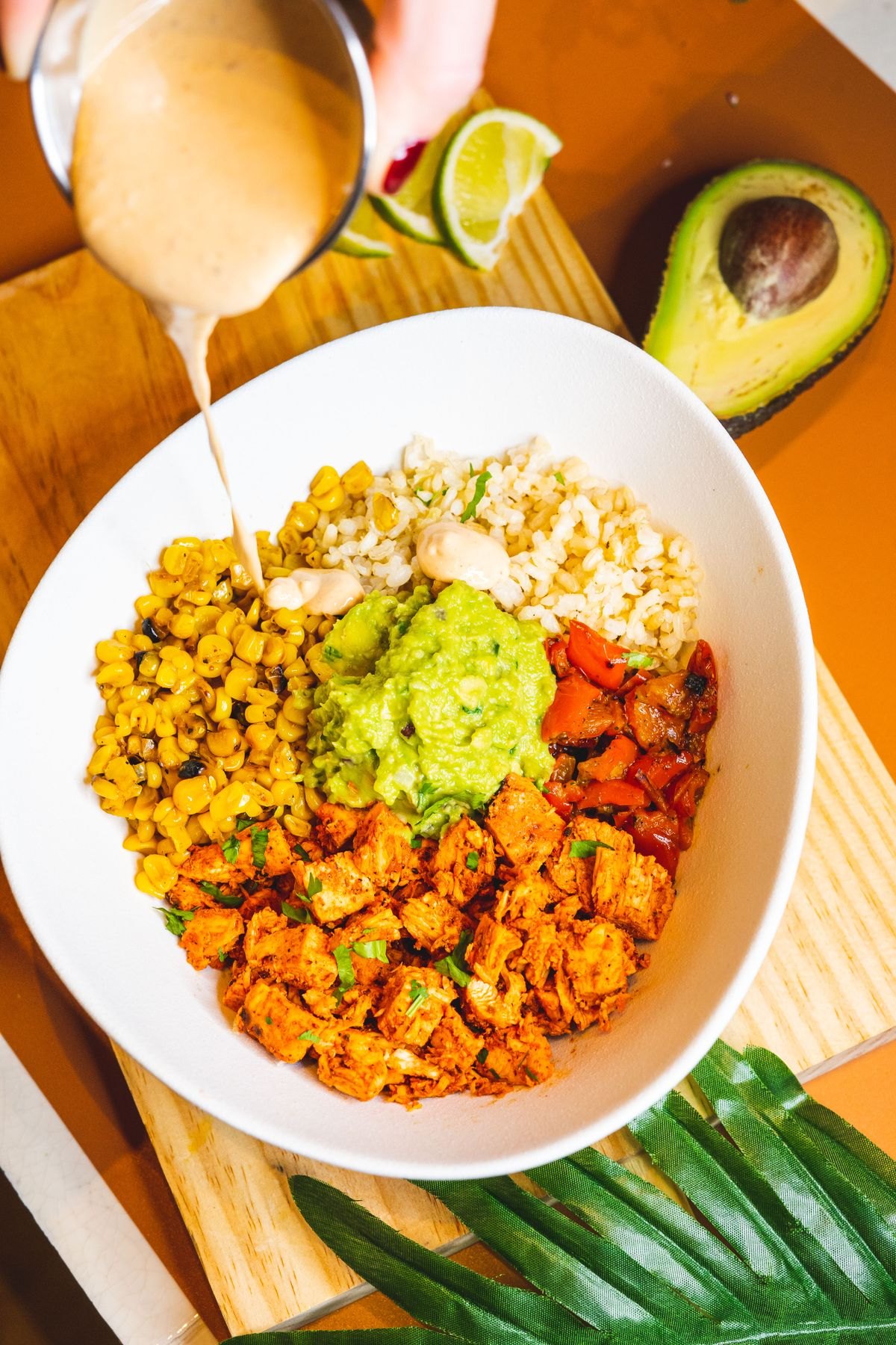 Colorful Mexican rice bowl with avocado and seasoned filling